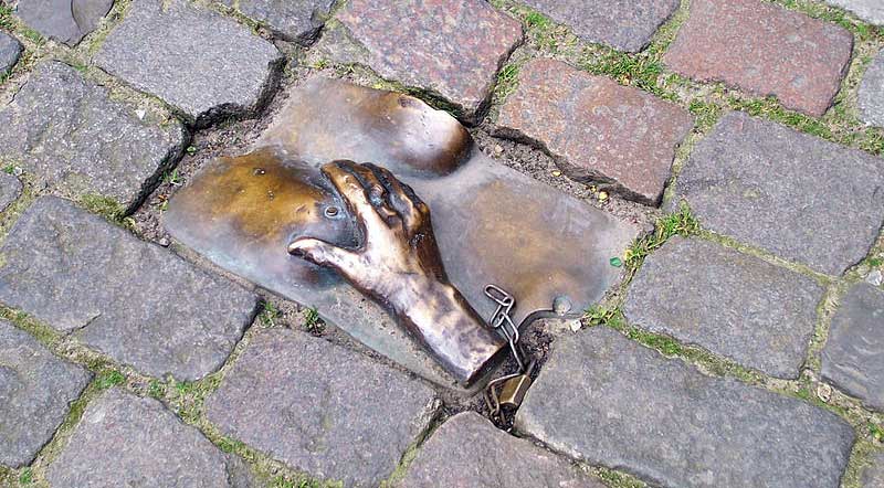 Hand grabbing a breast, set into the pavement in Amsterdam